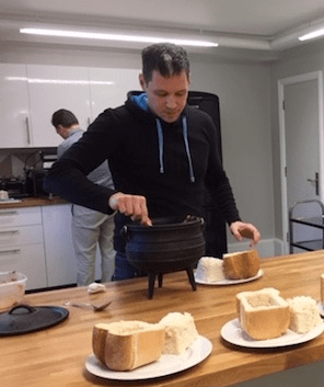 Scott serving up traditional South African bunny chow for his teammates